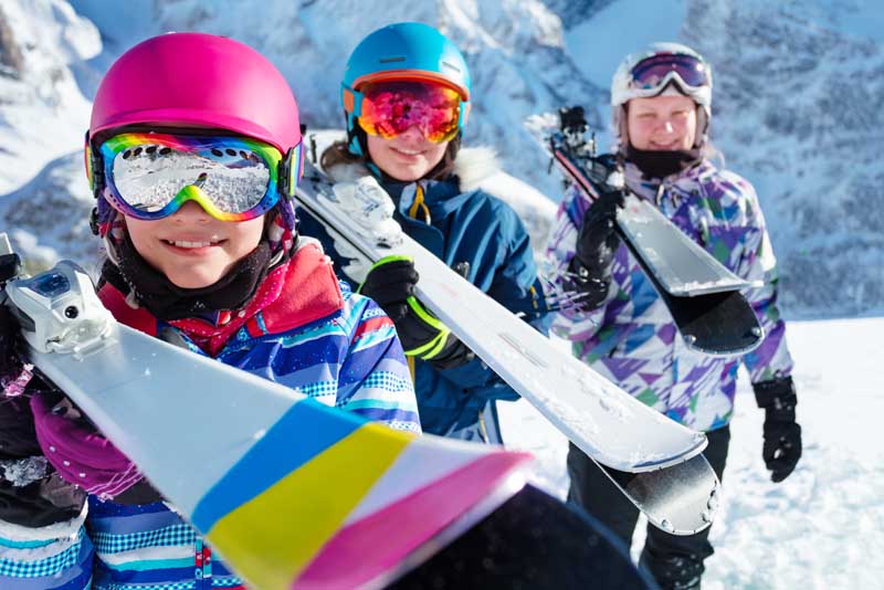 Image of a group of young skiers ready to take to the slopes.