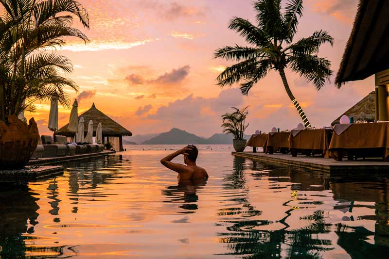 An image of a man bathing in a tropical lagoon